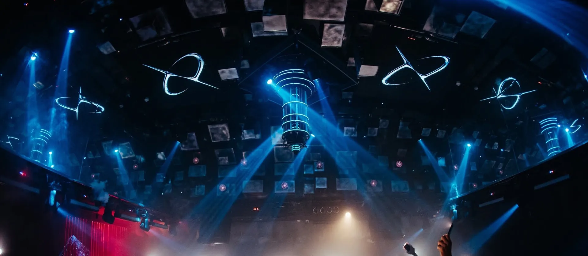 Cosmos Club Hanoi — blue beams cutting through haze under the orbit LED ceiling